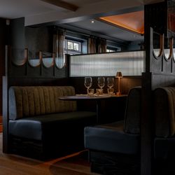 Elegant restaurant booth with set table and dim lighting