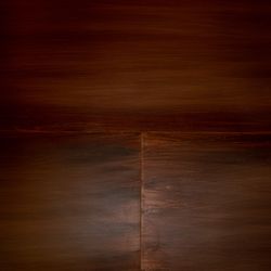 Dark brown wooden surface with subtle grain texture