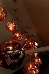 Cluster of amber glass pendant lights hanging from the ceiling