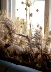 Dried floral arrangement on a windowsill