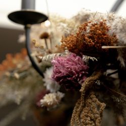 Close-up view of dried flowers and foliage on a decorative arrangement