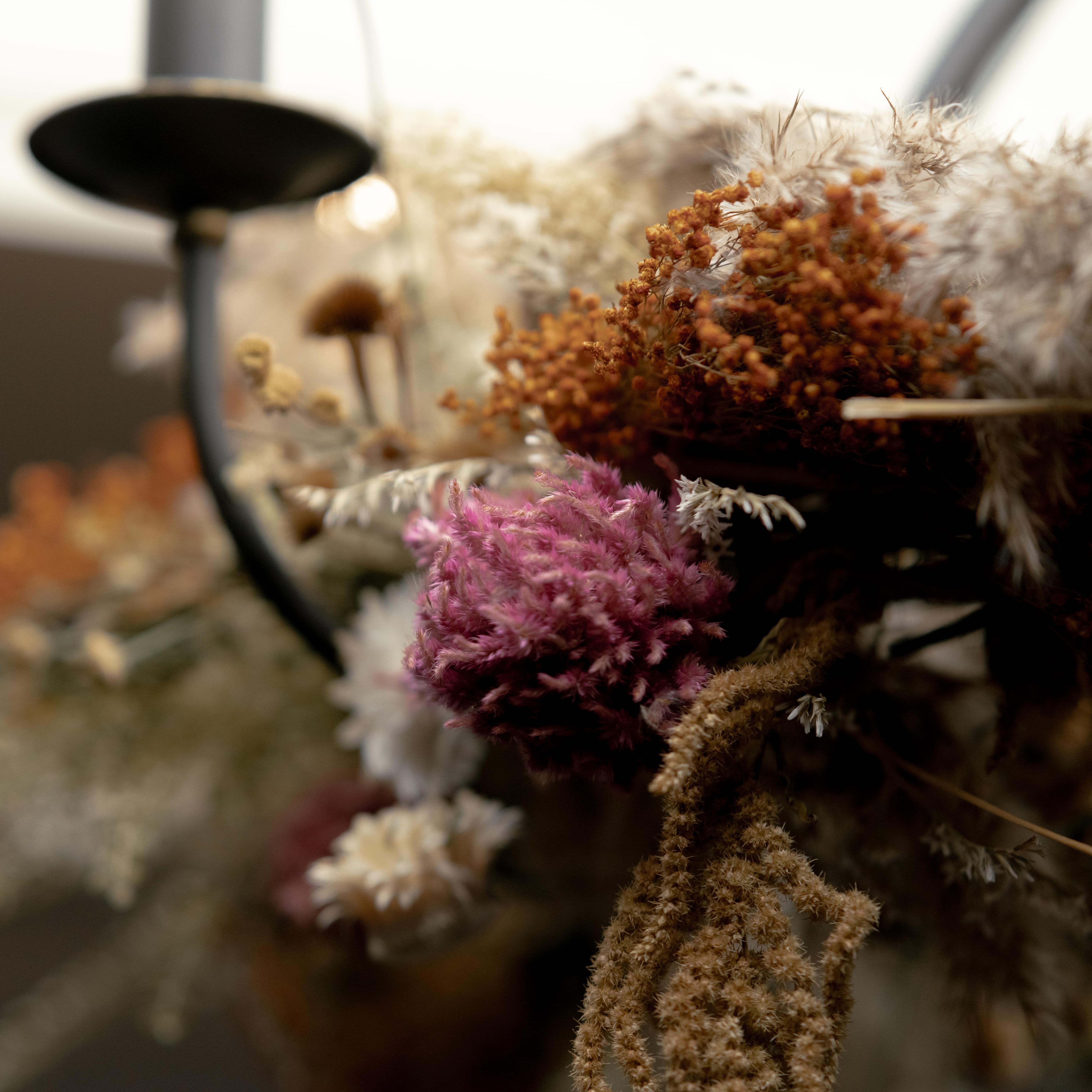 Close-up view of dried flowers and foliage on a decorative arrangement