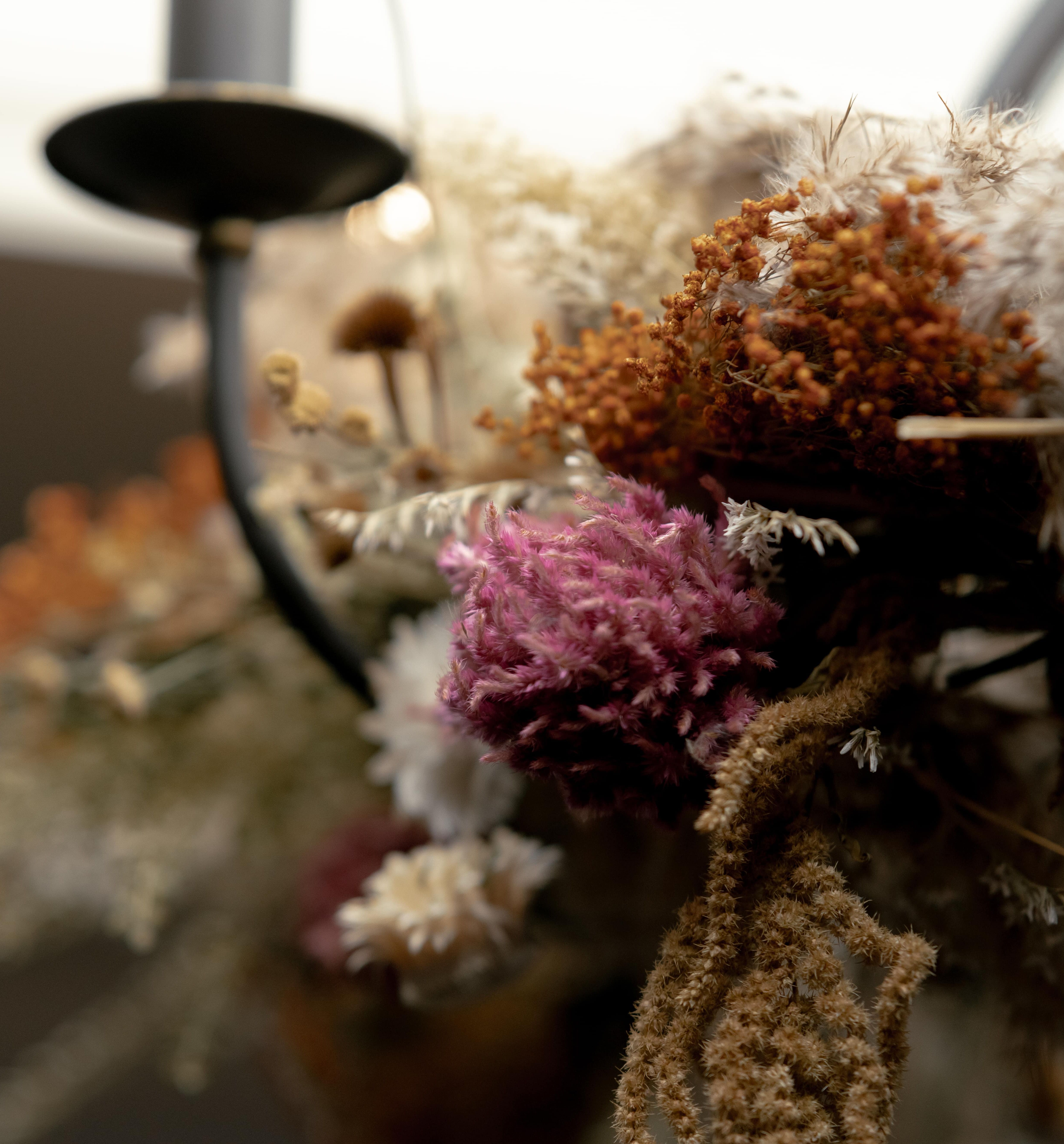 Close-up view of dried flowers and foliage on a decorative arrangement