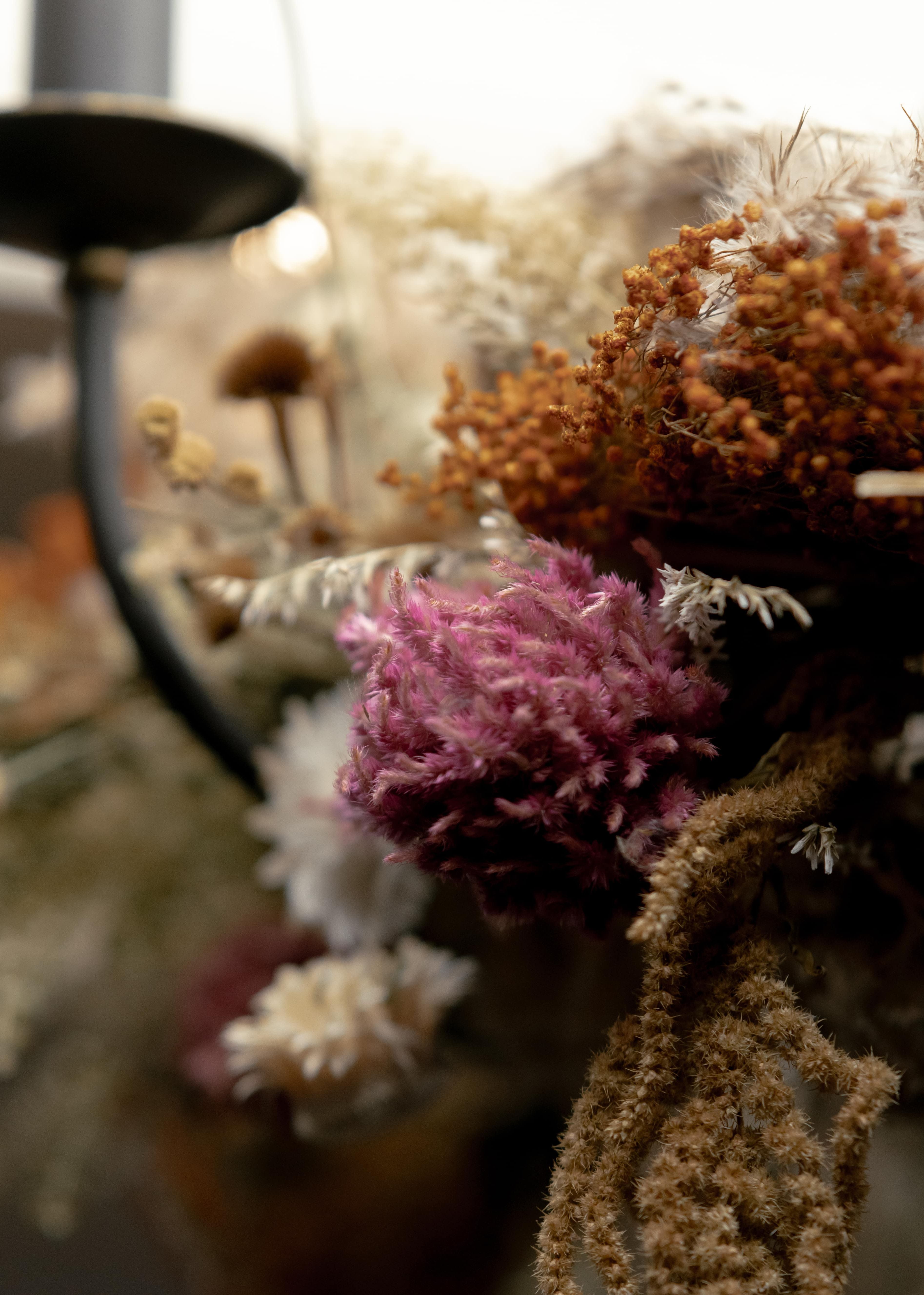 Close-up view of dried flowers and foliage on a decorative arrangement