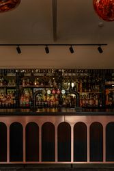 Modern bar area with a variety of bottles and beer taps.