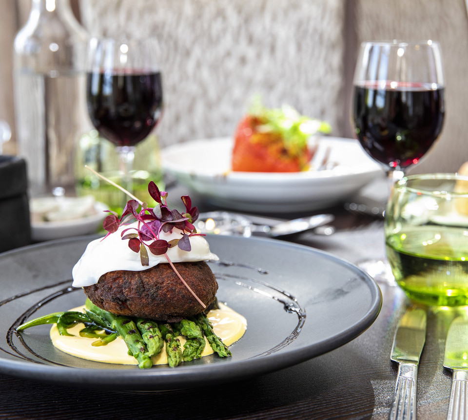 Main course with wine on dining room table