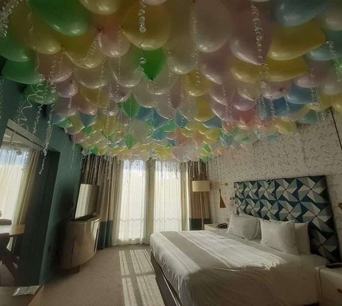 Room with many colorful balloons attached to the ceiling