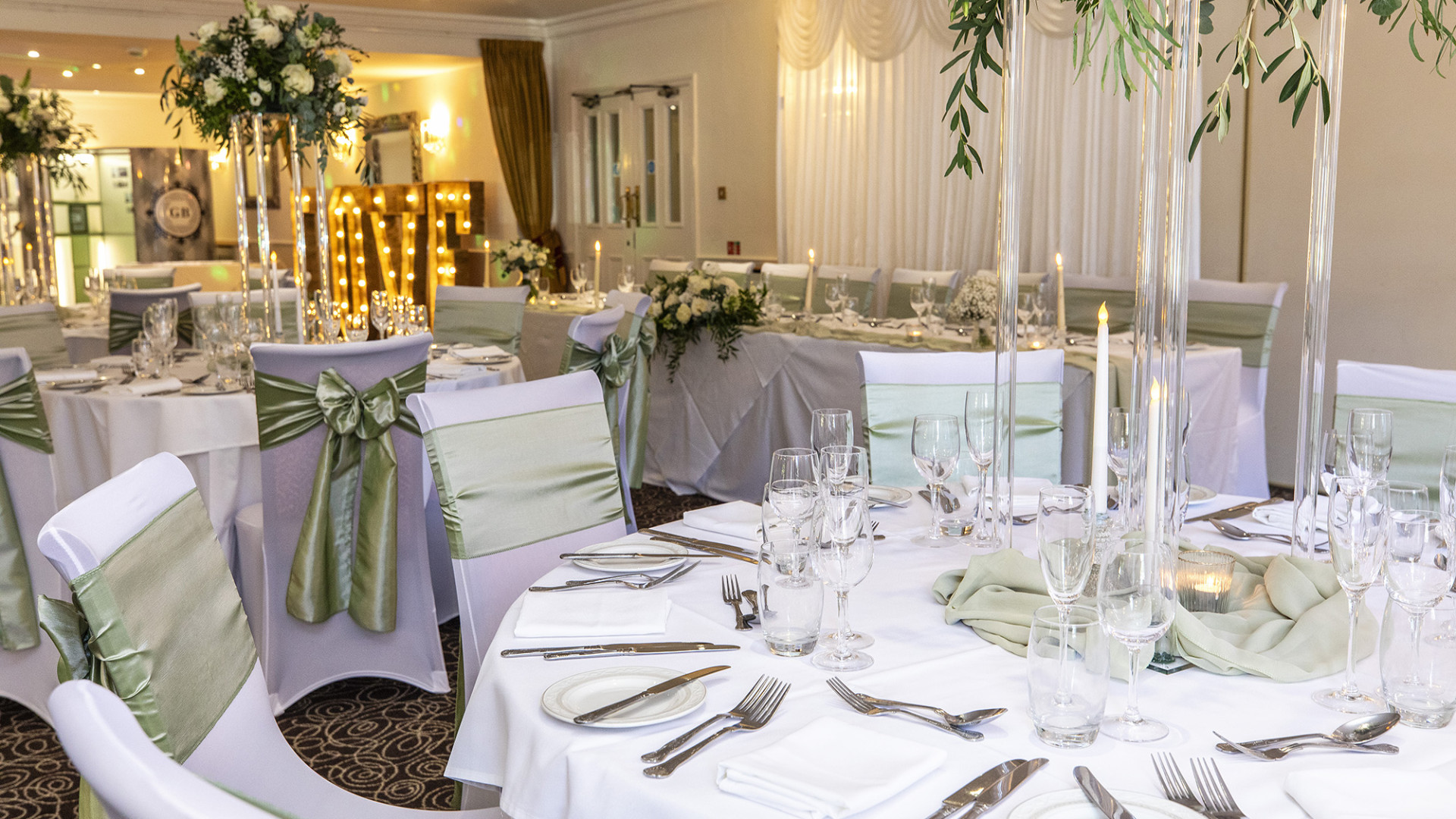Wedding room set up with green ribbons and flowers