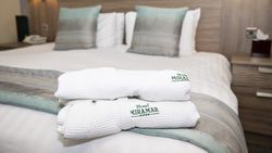 Hotel Miramar robes on bed