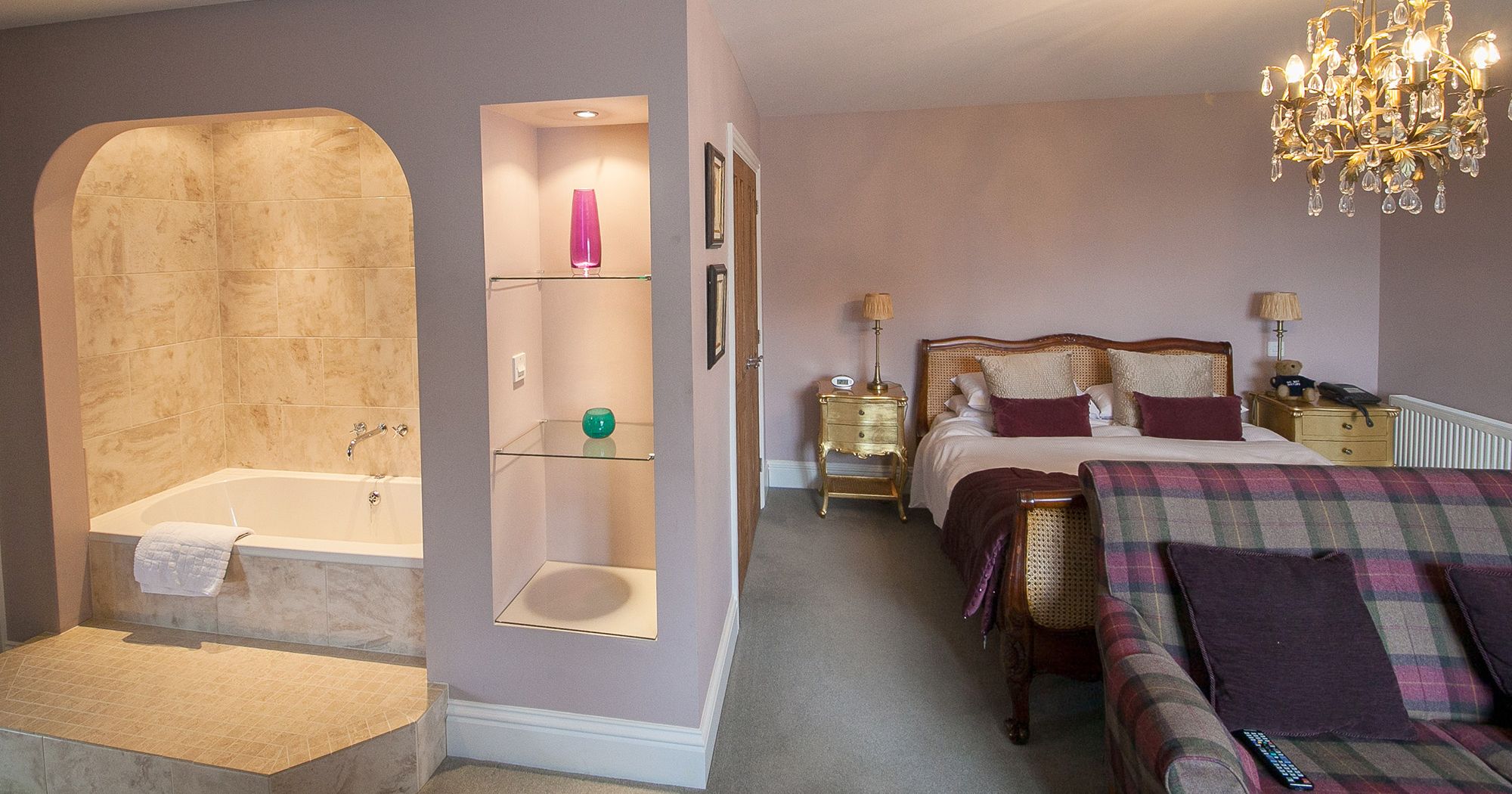 magnificent hotel suite with standalone bath and crystal chandelier