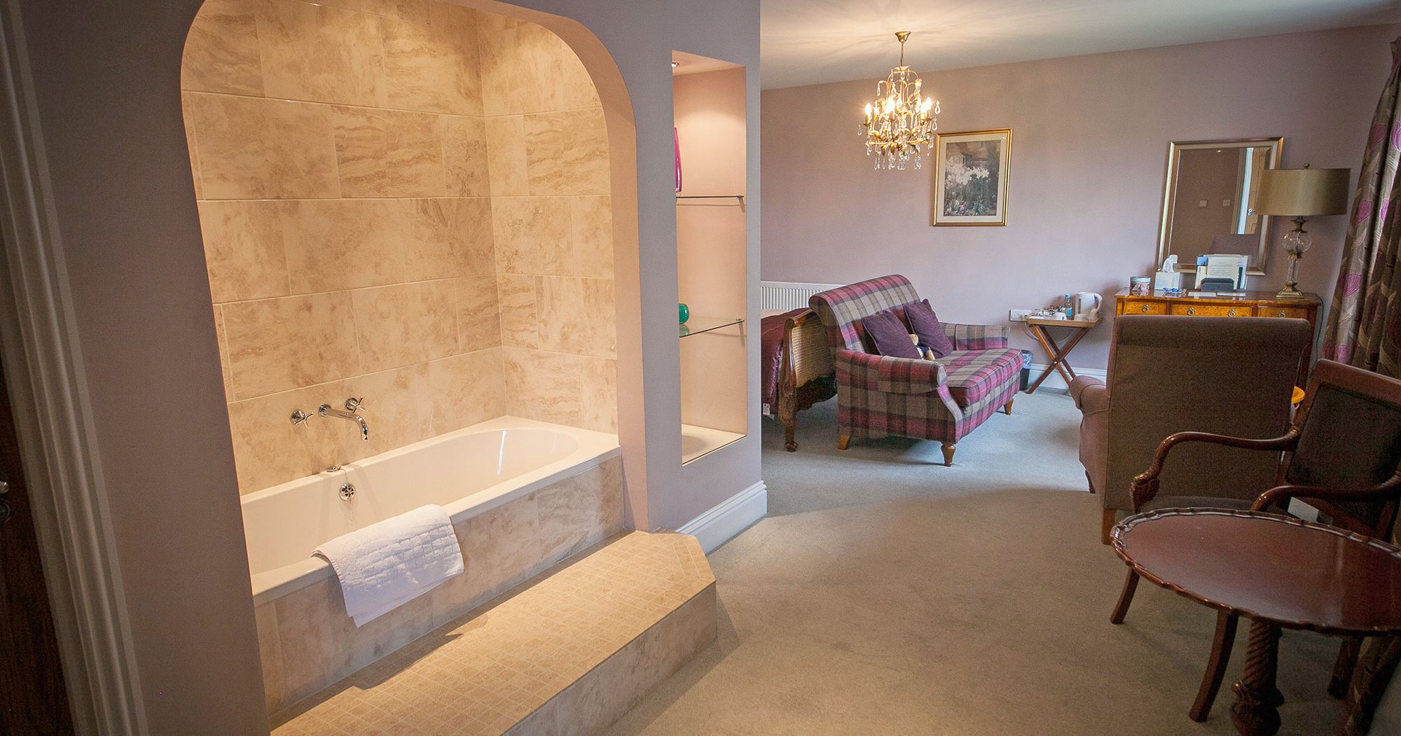 magnificent hotel suite with standalone bath and crystal chandelier