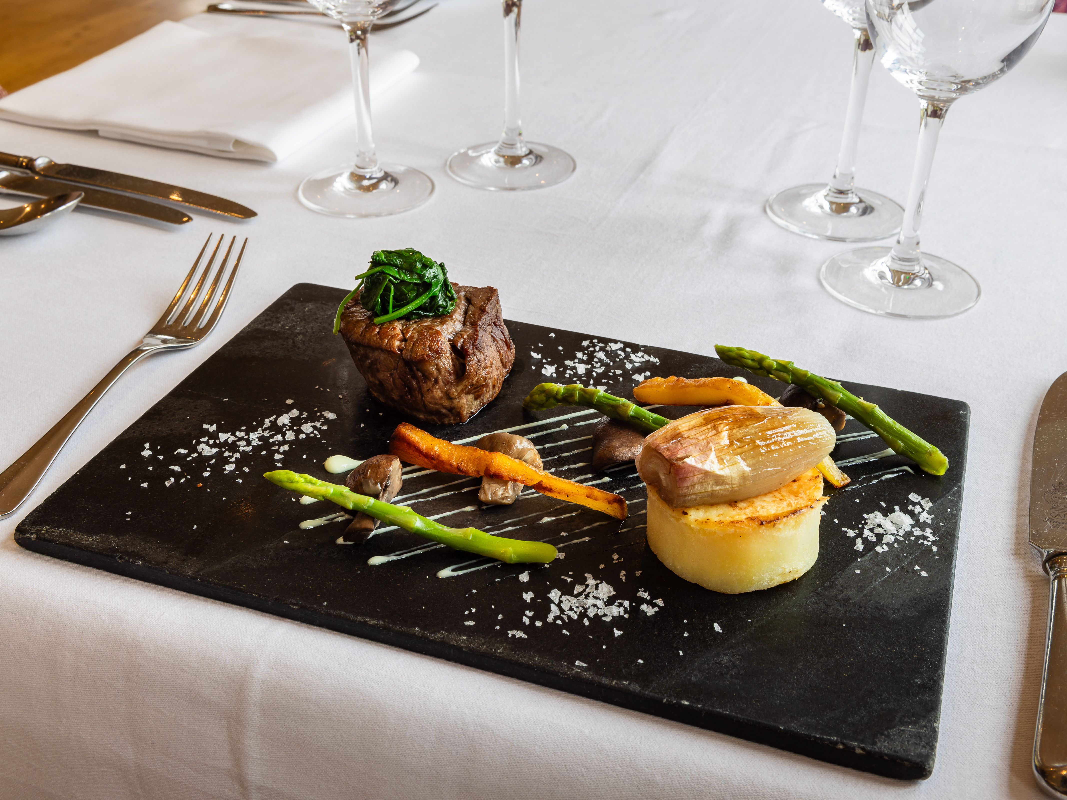 beef with fondant potatoes and fresh vegetables