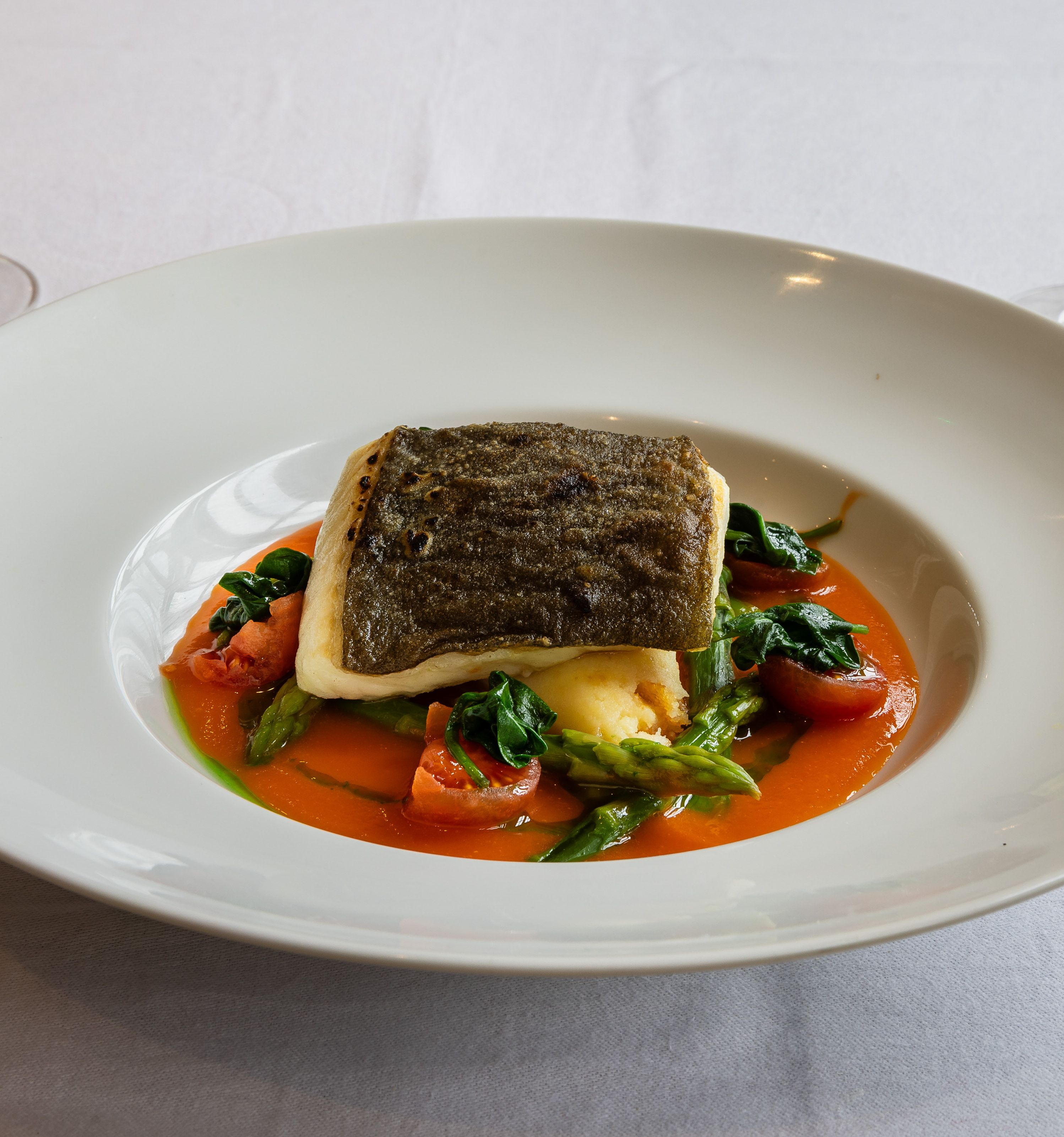 fish served with a tomato base sauce