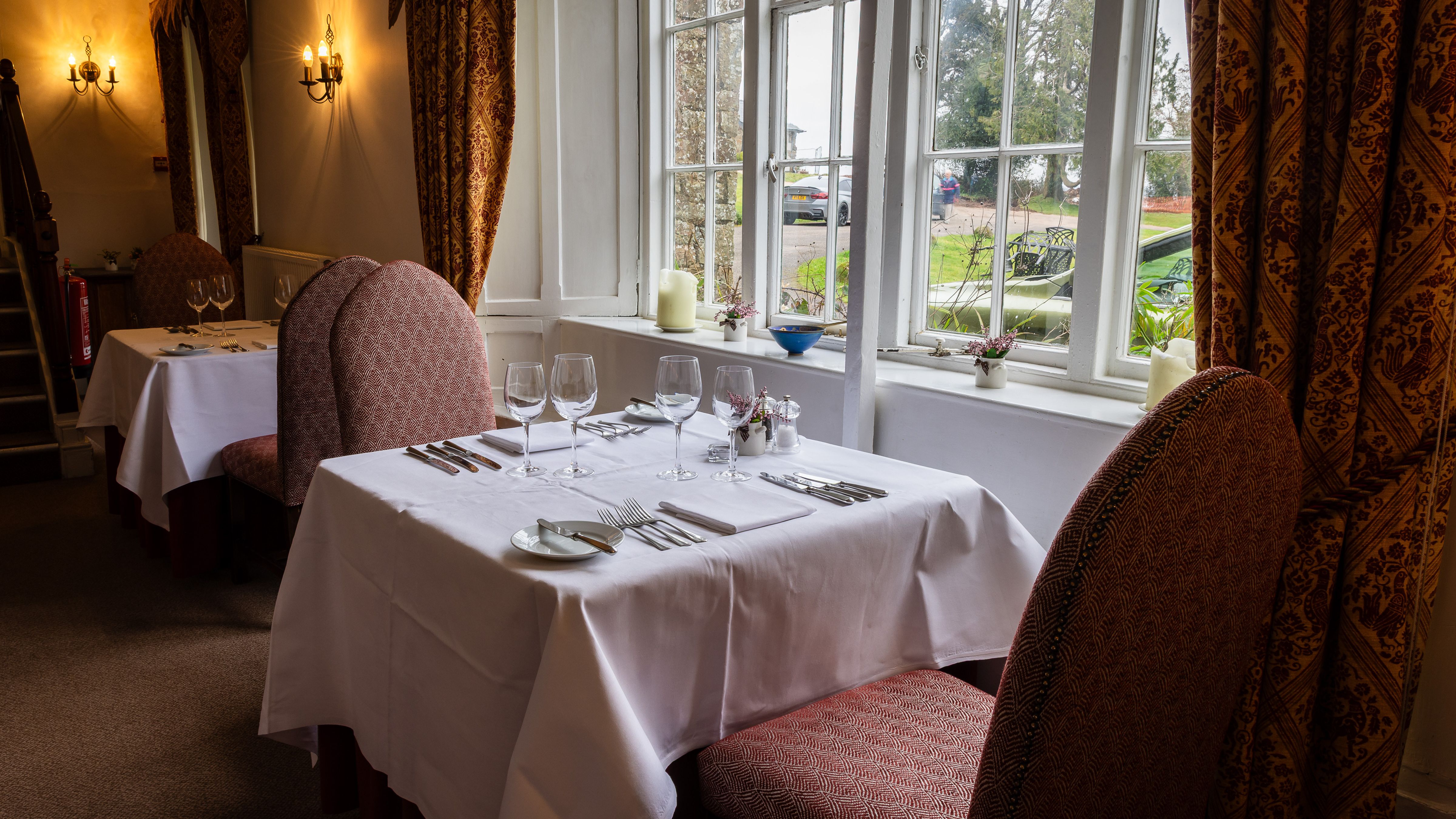 Table for two in the window of the dining room looking out across the garden