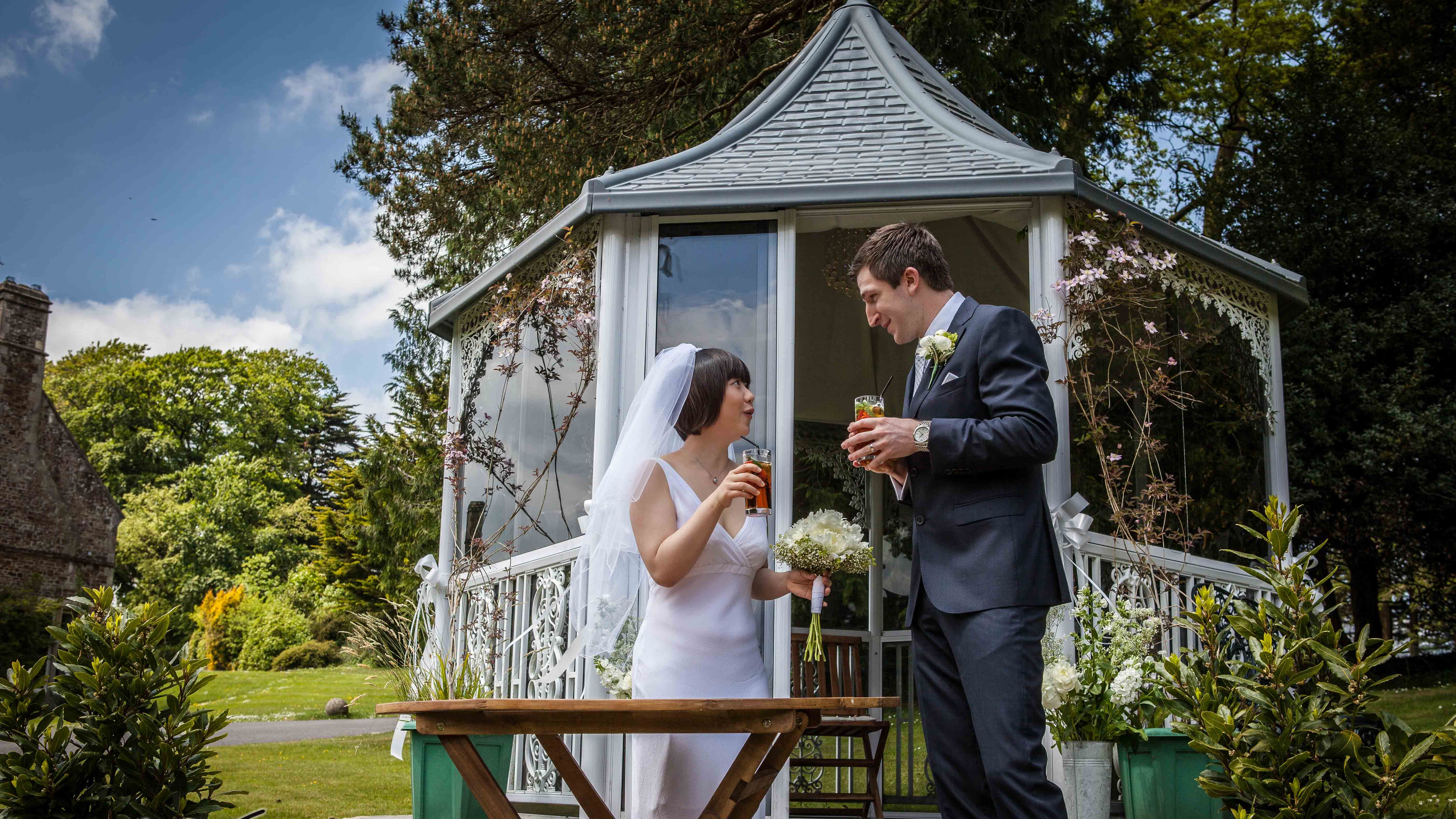 Couple stood infront of Gazebo getting married