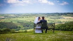 Couple sitting on a bench overlooking the Devon countryside
