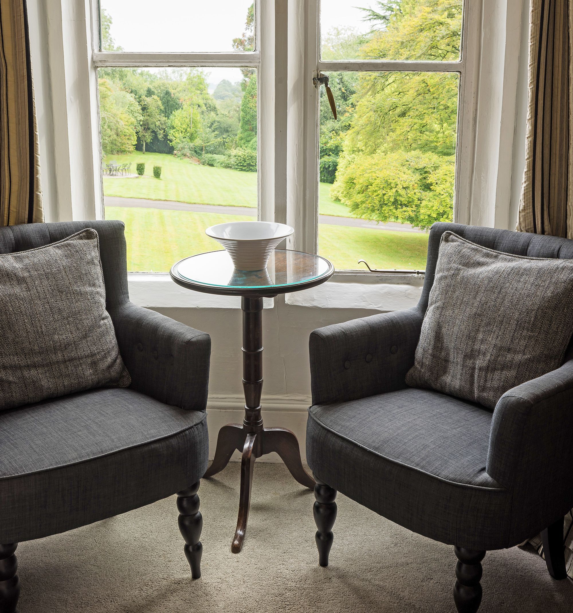stylish hotel room chairs next to window