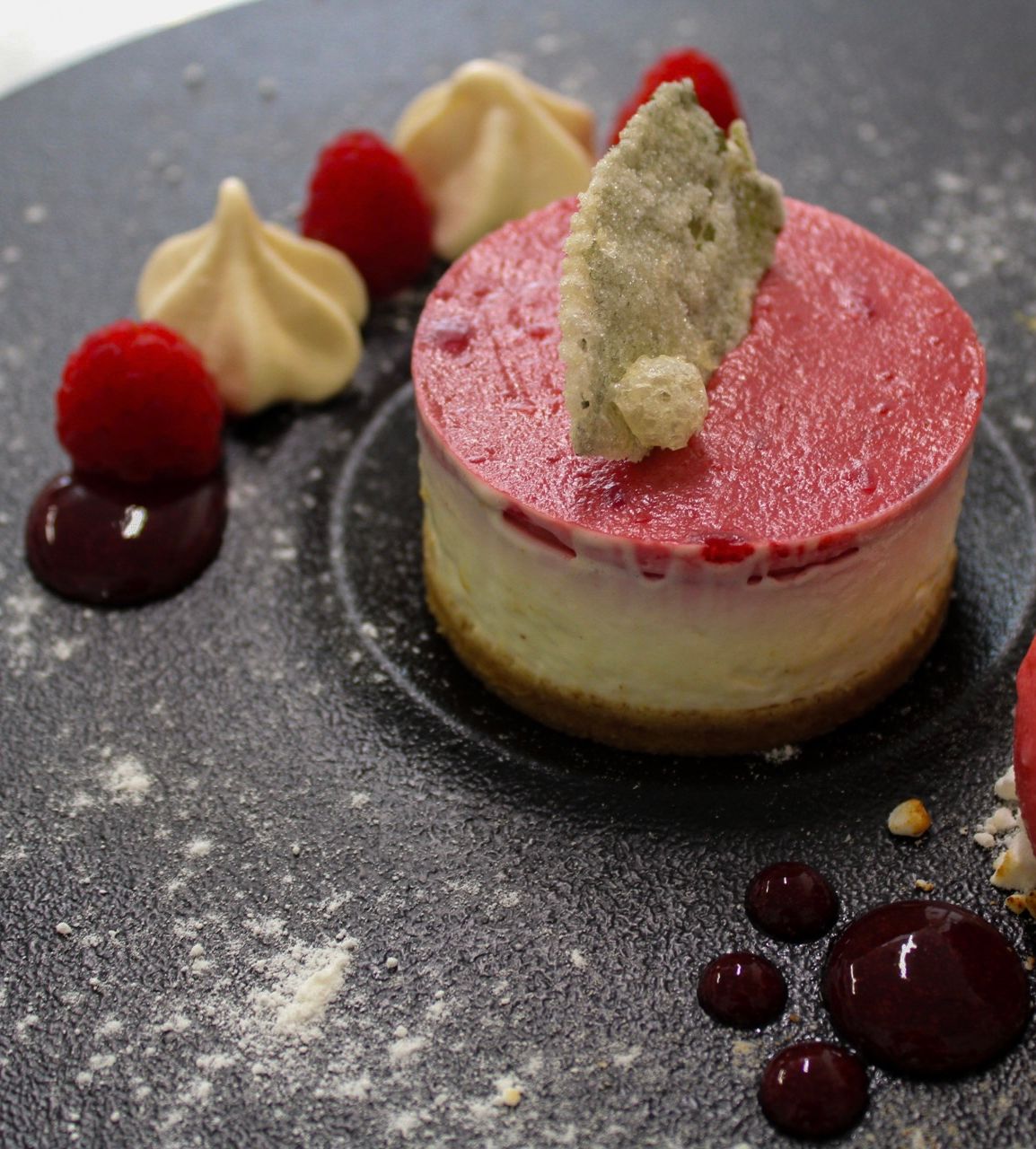 eton mess cheesecake with raspberry sorbet, candied mint leaves and fresh berries