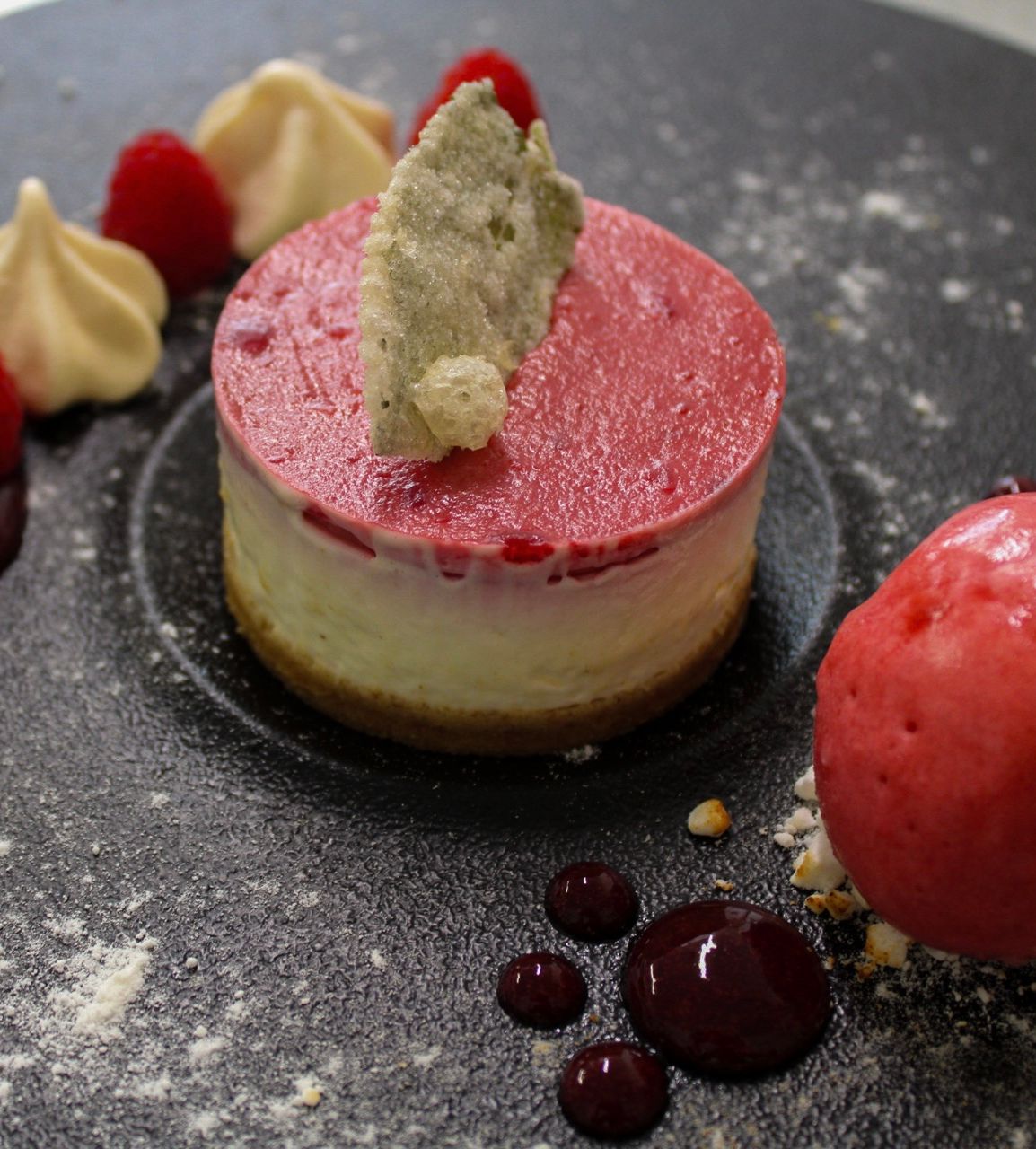 eton mess cheesecake with raspberry sorbet, candied mint leaves and fresh berries