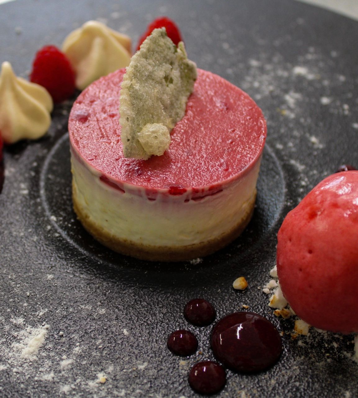 eton mess cheesecake with raspberry sorbet, candied mint leaves and fresh berries