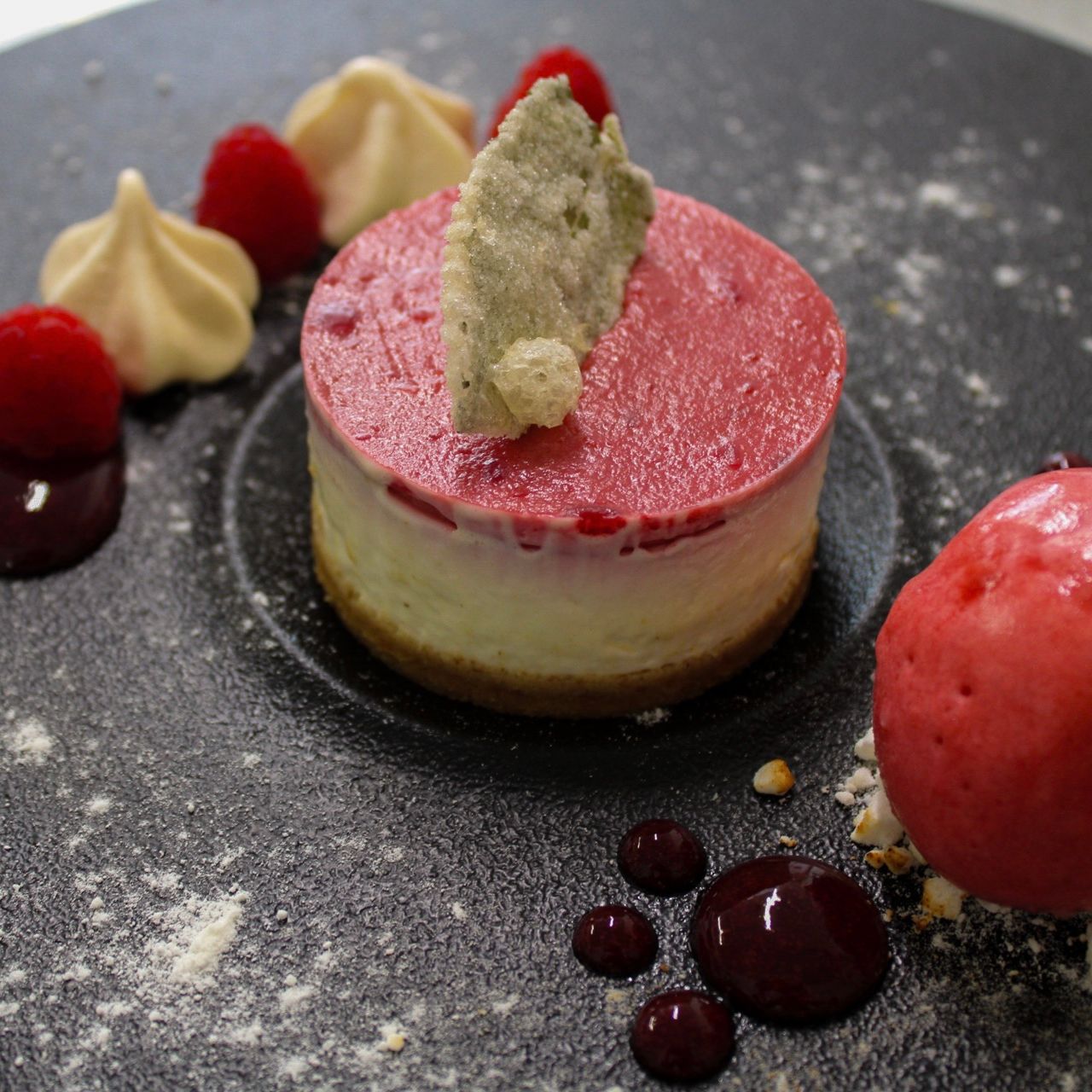 eton mess cheesecake with raspberry sorbet, candied mint leaves and fresh berries