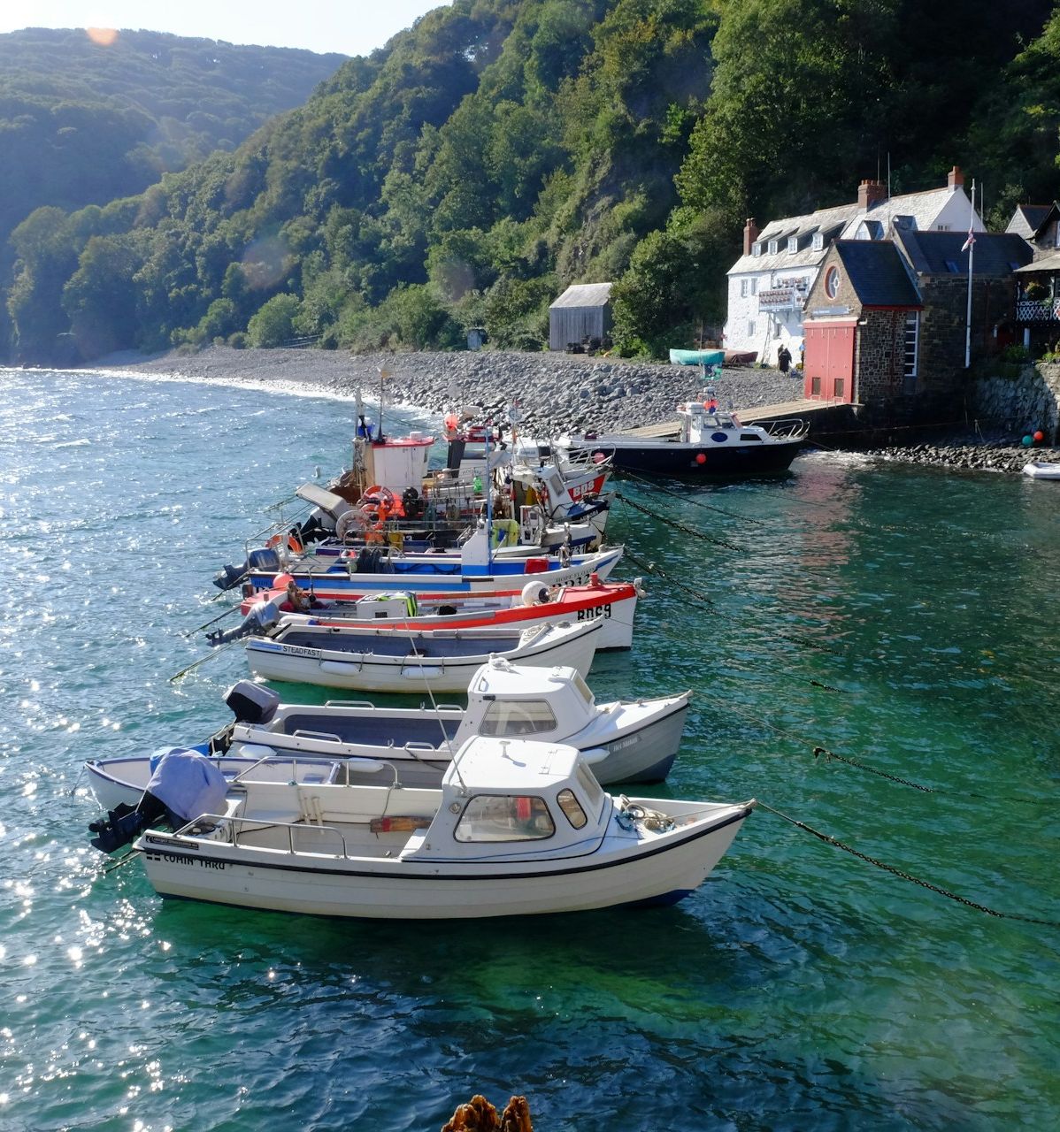 boats on blue water infront of houses