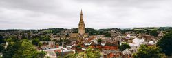 erial view of Exeter city with historic buildings and church spire in Devon
