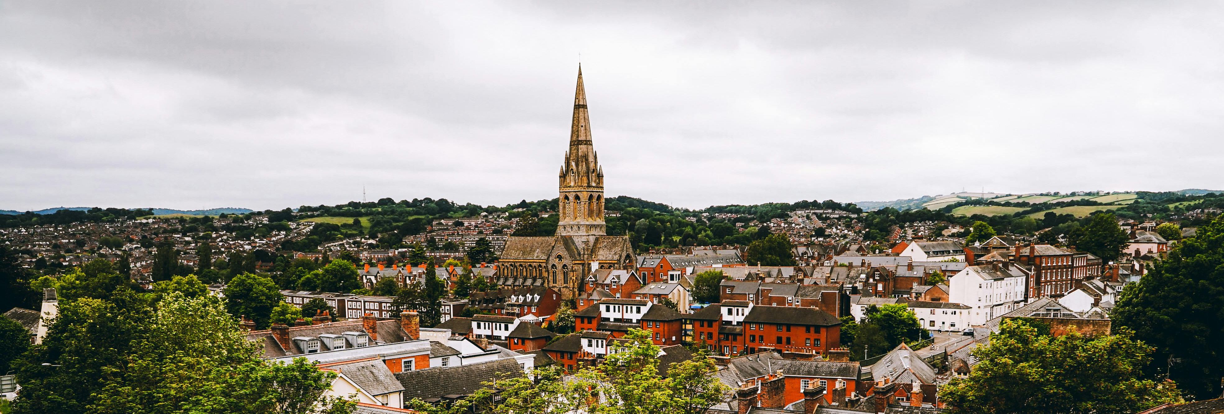 erial view of Exeter city with historic buildings and church spire in Devon
