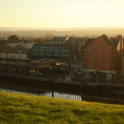 Exeter Quayside at sunset with warm golden light on buildings and riverfront