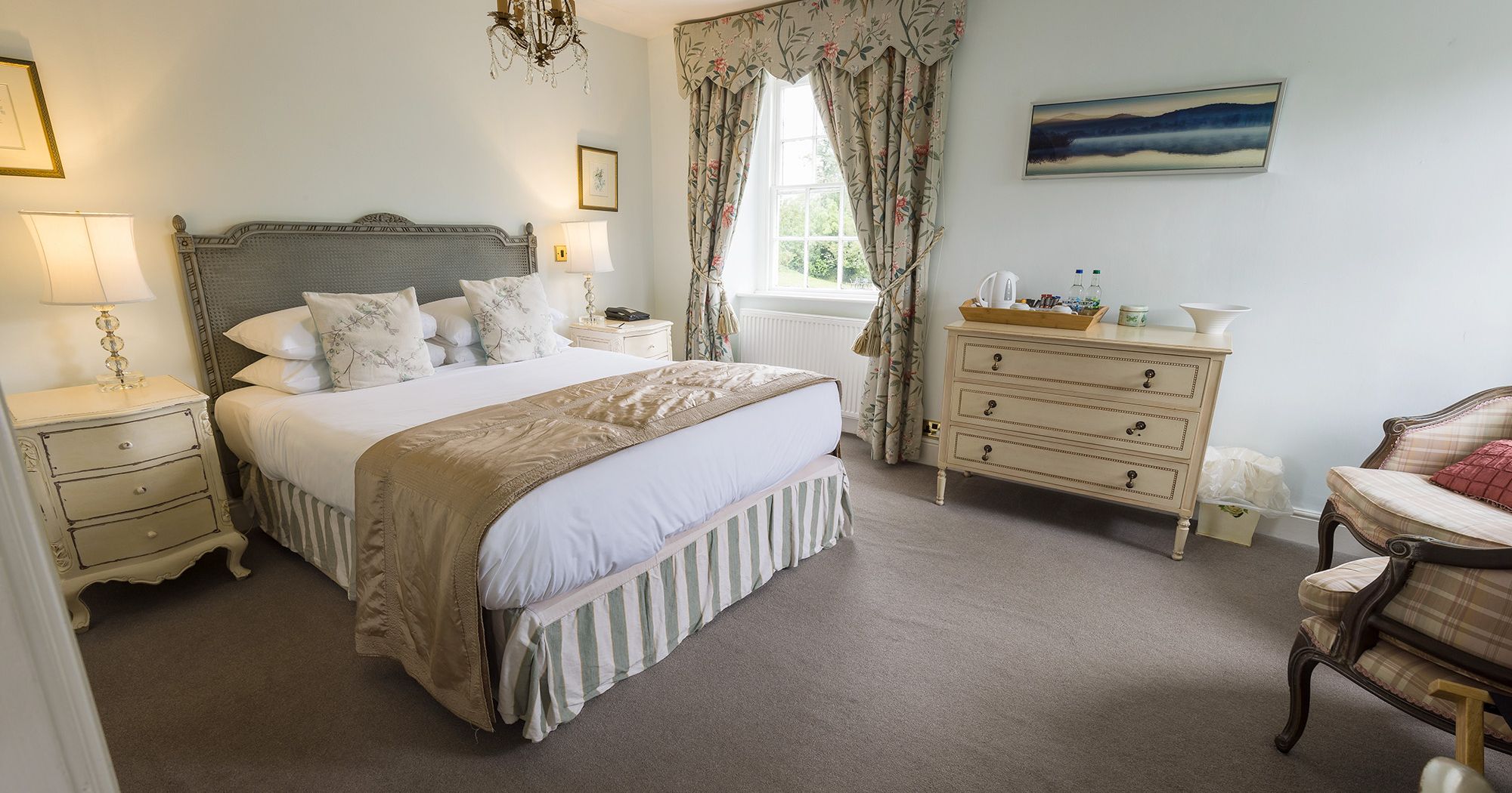 neutral and calm hotel room in light greens and golds