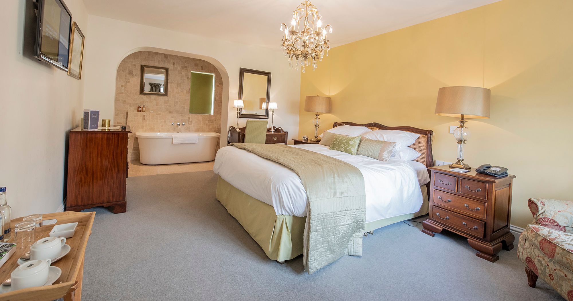 hotel room with crystal chandelier and free-standing bath