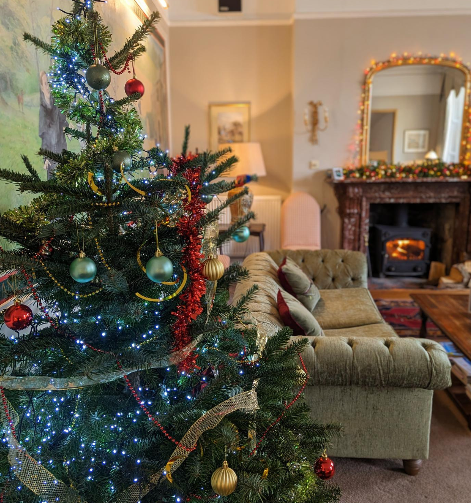 Decorated Christmas tree in a cozy living room with fireplace