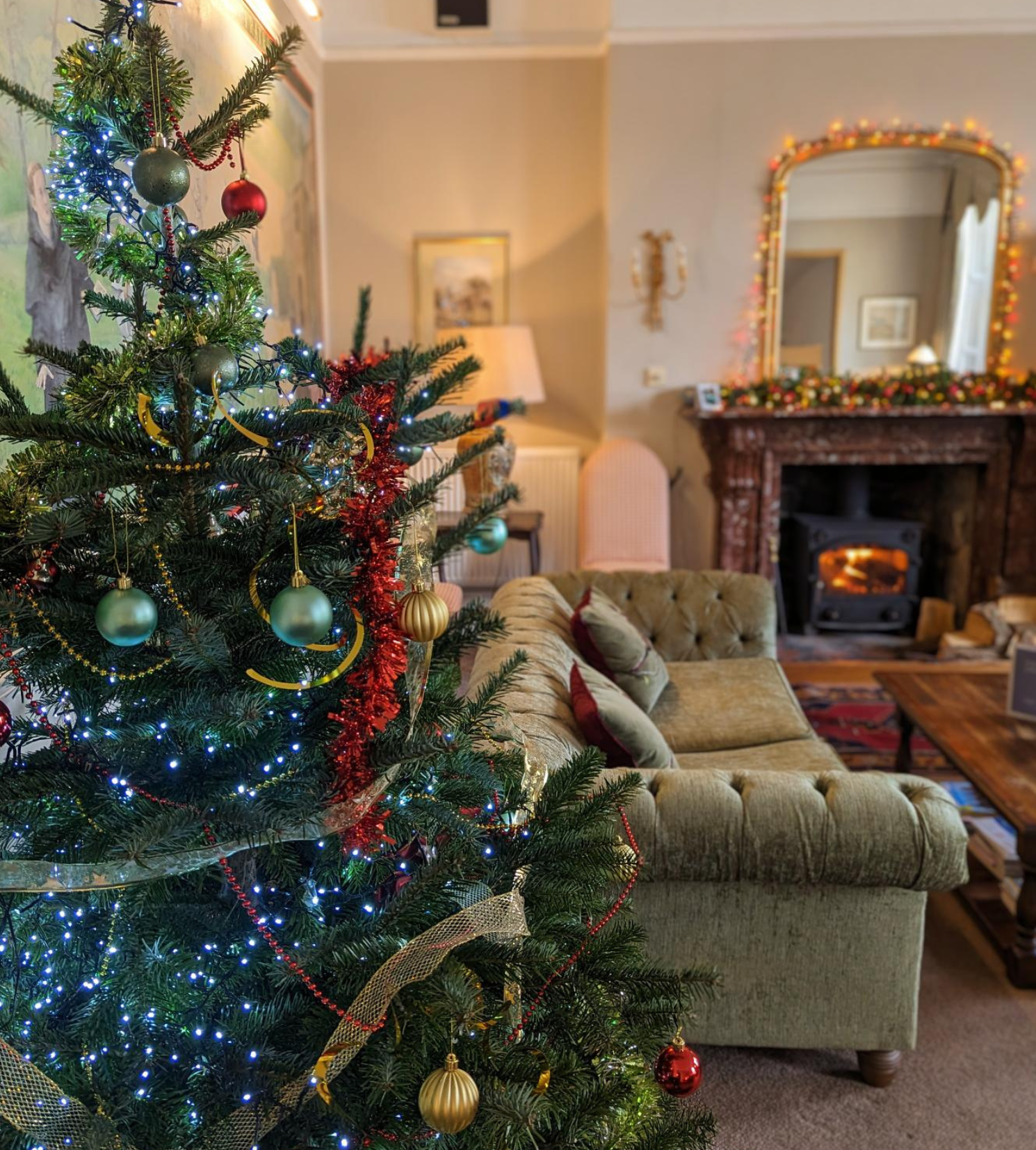 Decorated Christmas tree in a cozy living room with fireplace