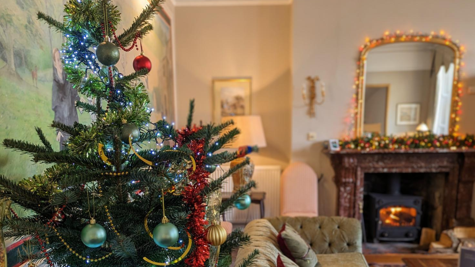 Decorated Christmas tree in a cozy living room with fireplace