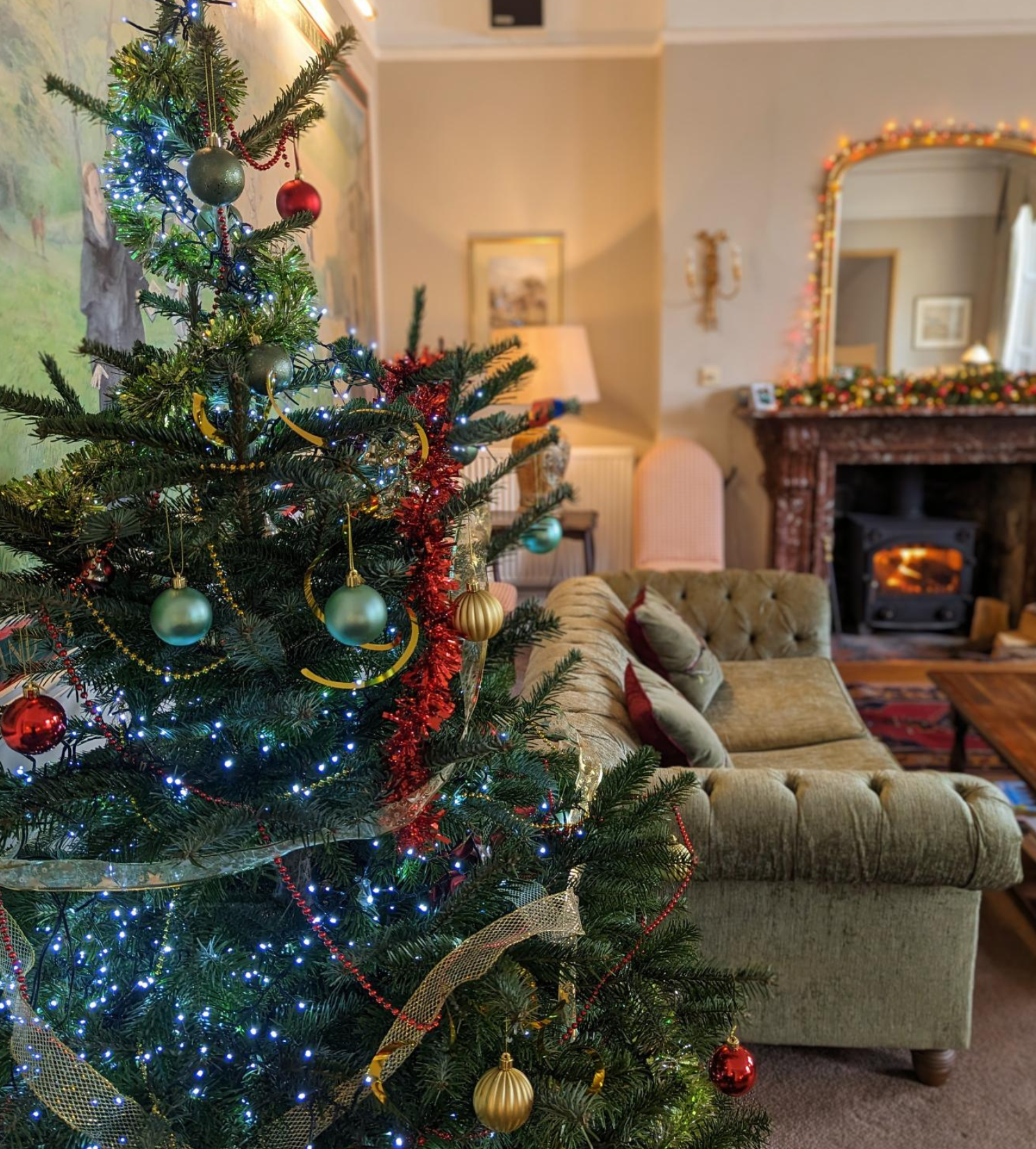 Decorated Christmas tree in a cozy living room with fireplace