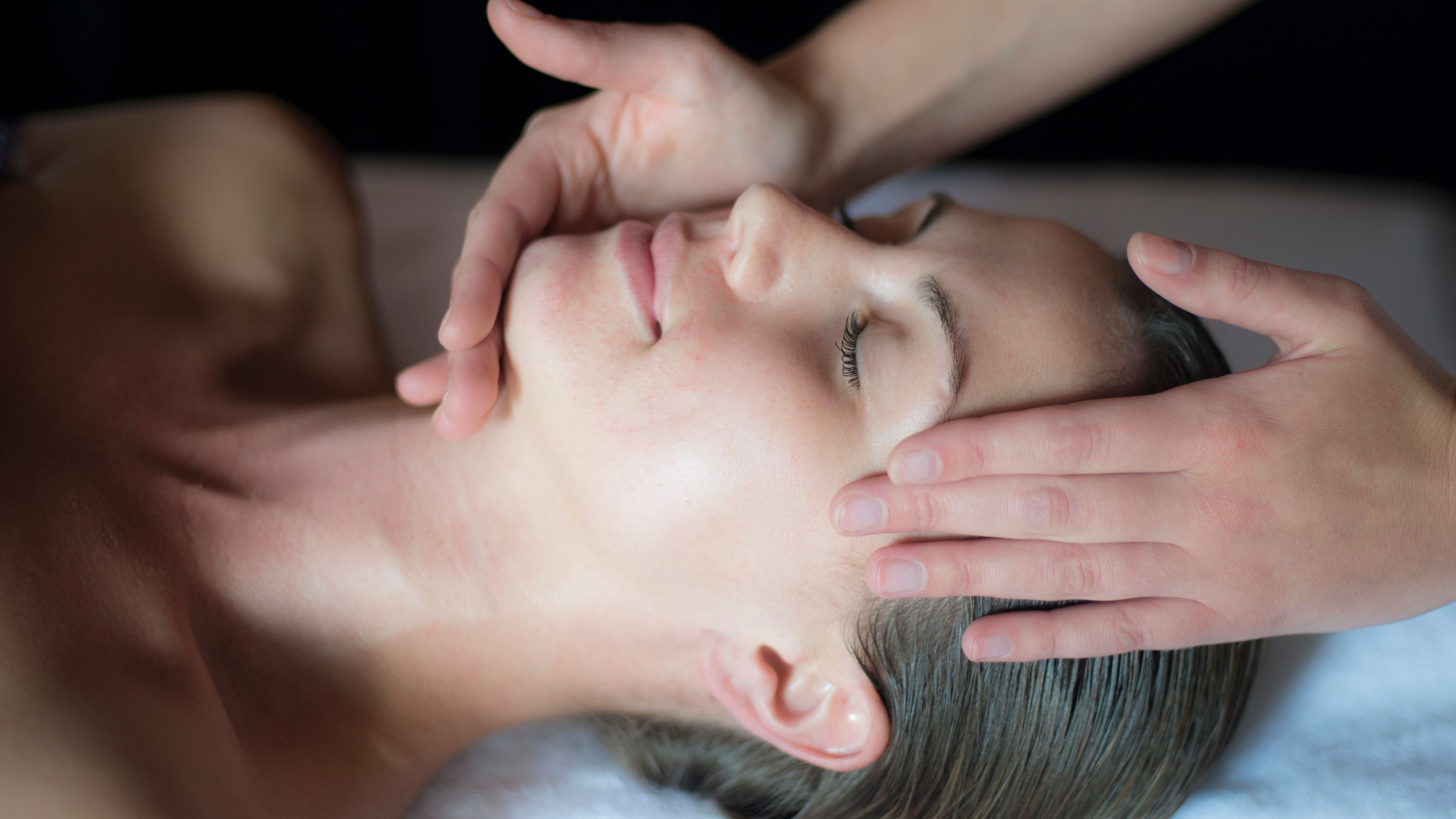 Person receiving a relaxing facial massage
