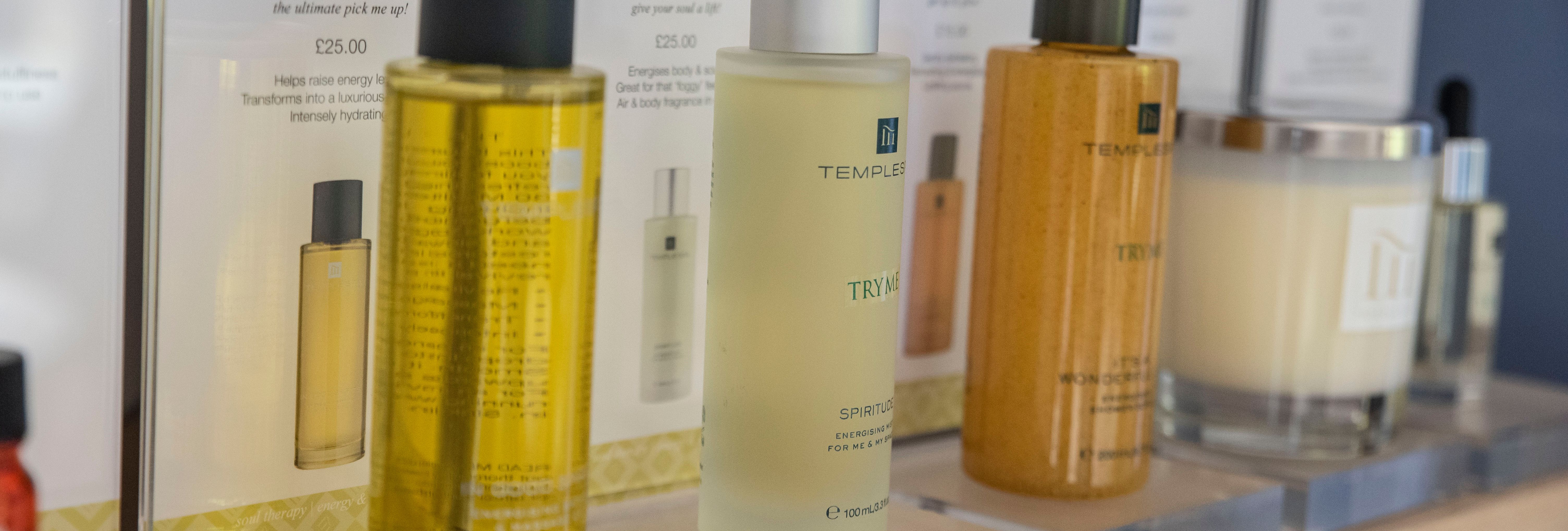 A row of Temple Spa skincare and wellness products displayed on a shelf.