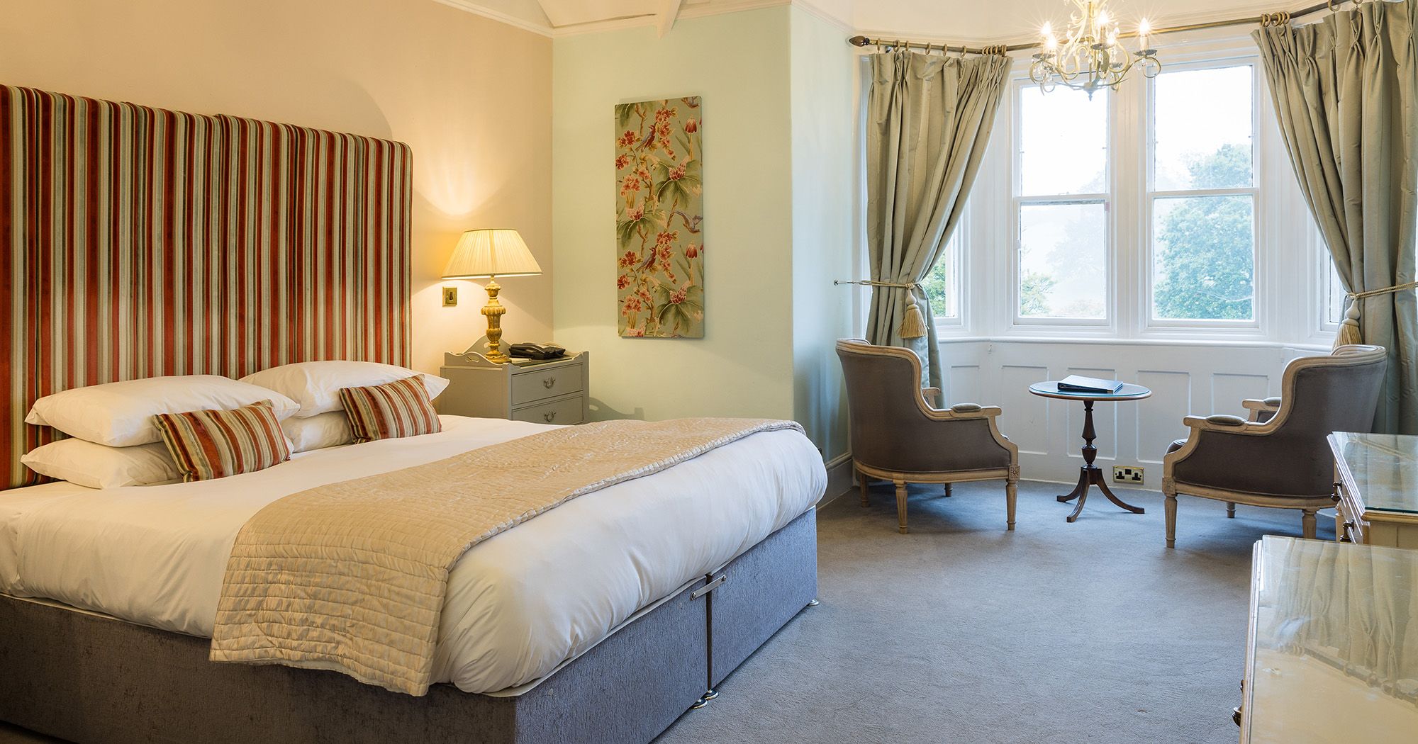 light and bright hotel bedroom suite with statement headboard