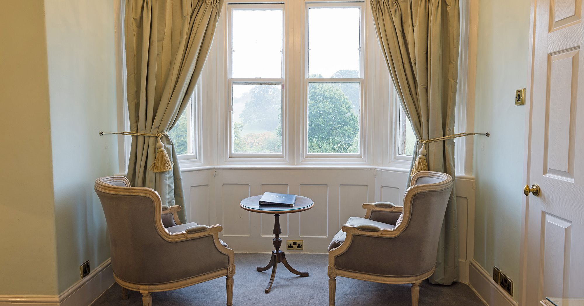 stunning period style table and chairs next to window hotel