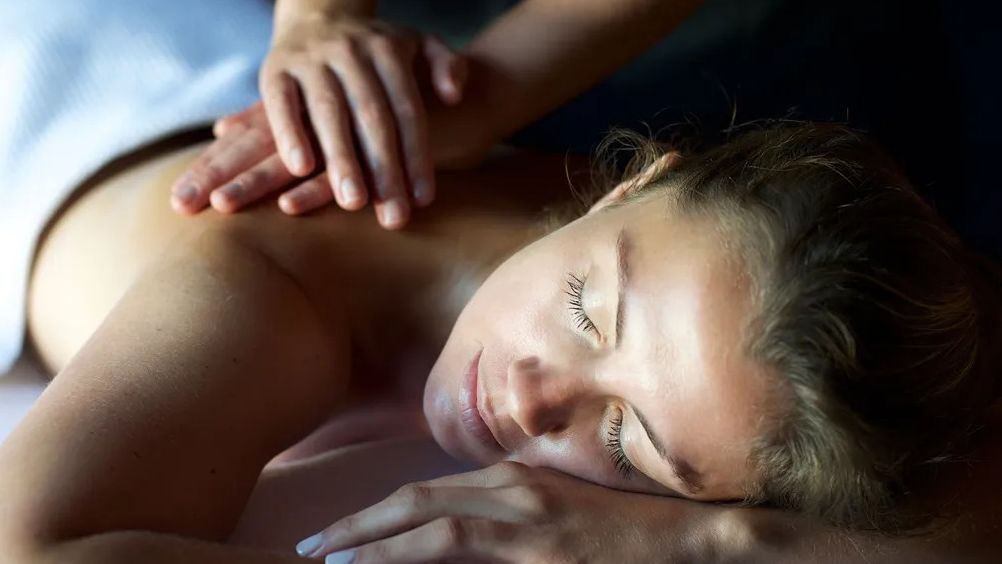 Woman receiving a relaxing back massage at a spa