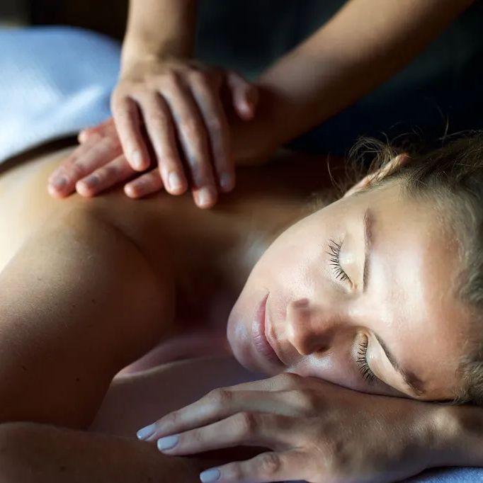 Woman receiving a relaxing back massage at a spa