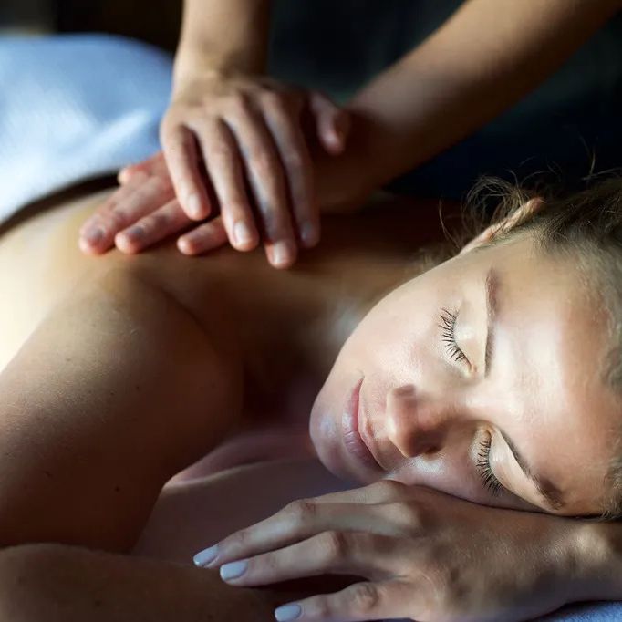 Woman receiving a relaxing back massage at a spa