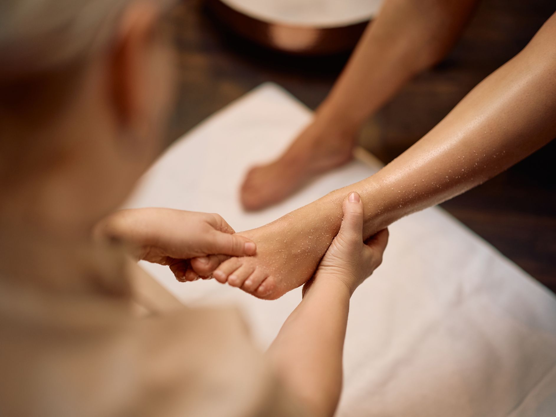 Close-up of a person receiving a foot massage at a spa