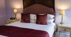 canopy bed and luxury bedding in bridal honeymoon hotel suite