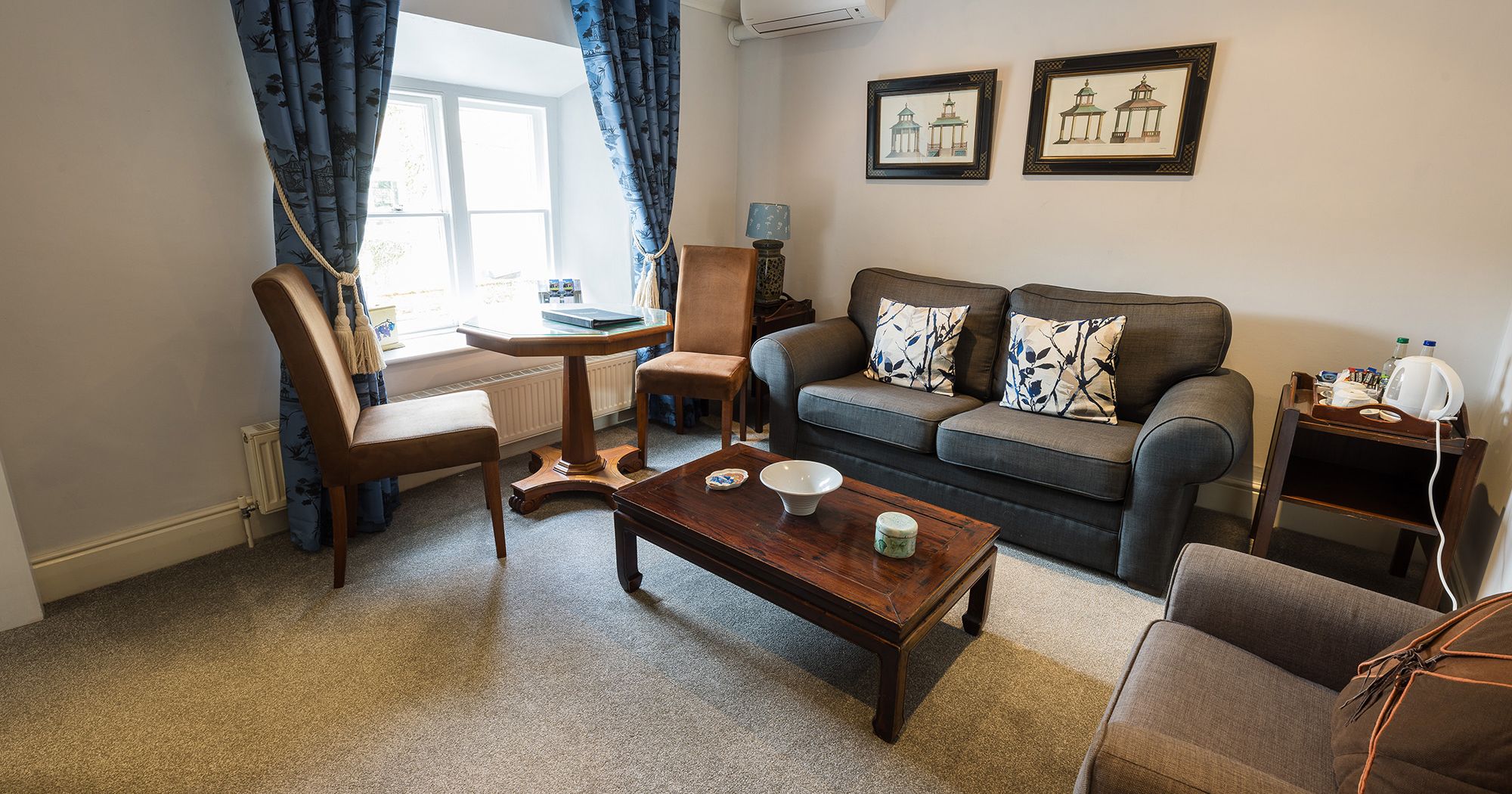 lavish hotel suite with two sofas, tables and chairs