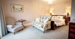 peaceful and large hotel suite with sofa