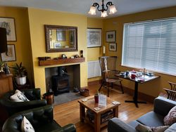 Snug with table for 2 for breakfast, chairs and sofa for guests' use and a log burner