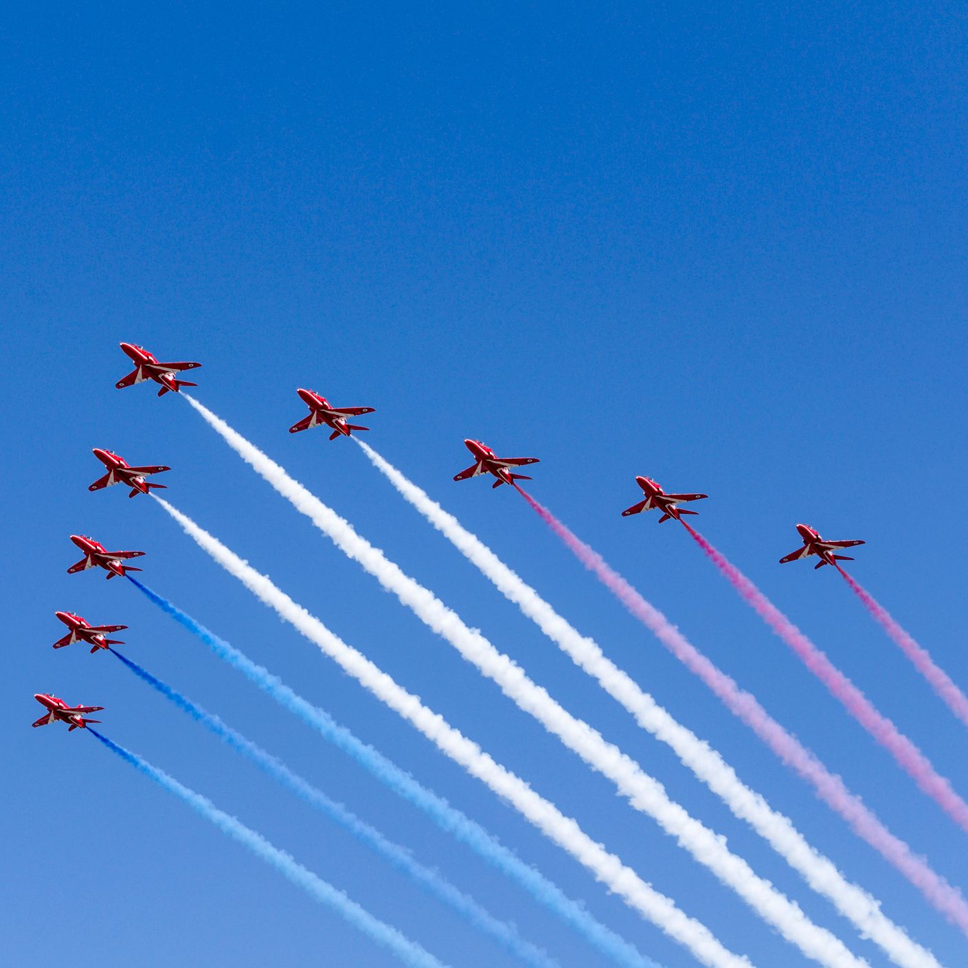 9 red arrows planes flying across the sky