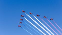 9 red arrows planes flying across the sky