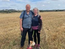 Tony and Julia in a field with their dog